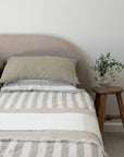 Tess Stripe linen bedding with tess pillowcases and a Cove linen throw and a dune linen throw.