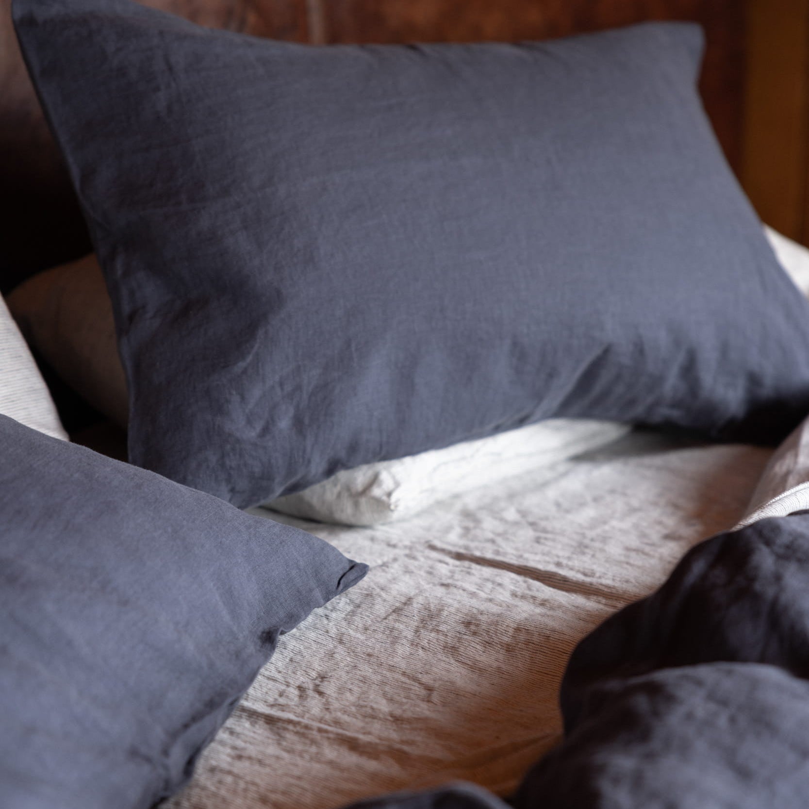 midnight blue linen bedding with a textured pattern on a bed.