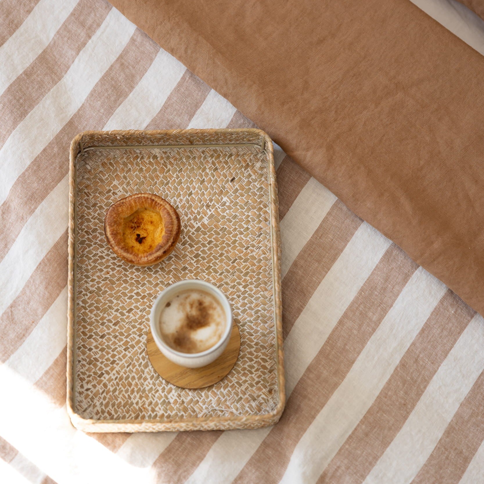 Hazelnut and Stripe linen bedding with coffee and pastry 